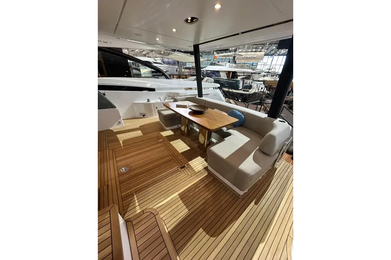  Yacht Photos Pics Luxurious 2024 Azimut Fly 68 yacht deck with elegant seating and wooden flooring.