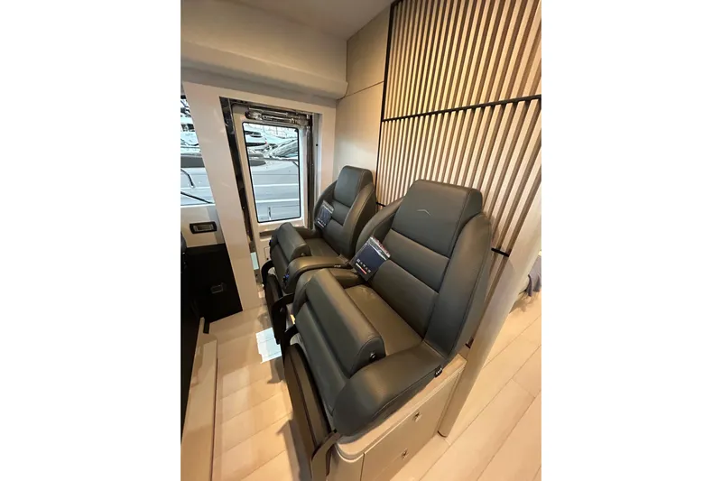  Yacht Photos Pics Luxurious seating inside 2024 Azimut Fly 68 yacht, featuring sleek leather design and modern aesthetics.
