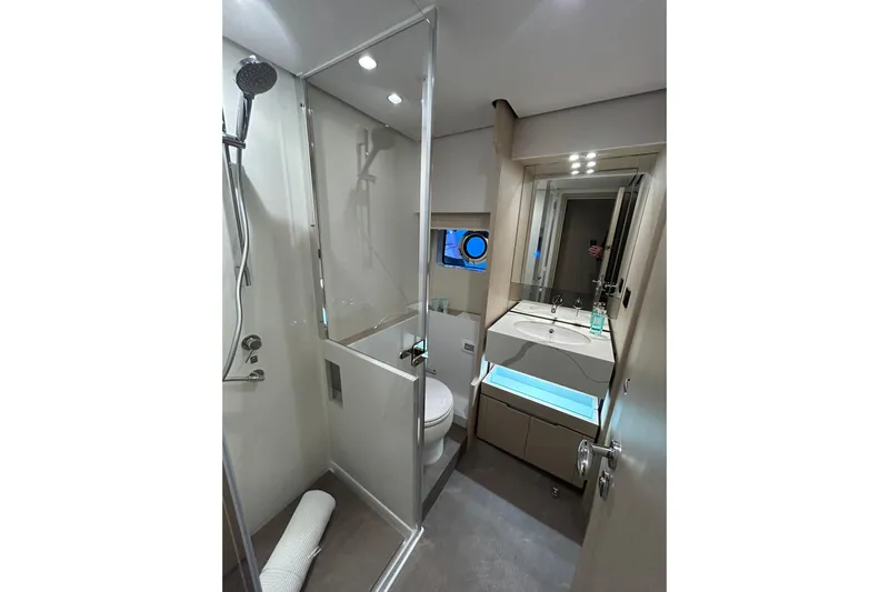  Yacht Photos Pics Luxurious bathroom in 2024 Azimut Fly 68 yacht, featuring modern shower and sleek vanity.