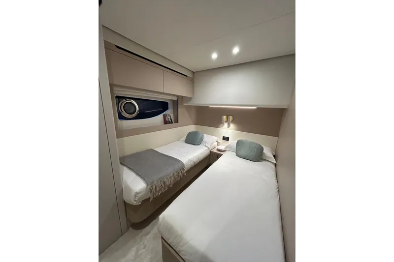  Yacht Photos Pics Luxurious twin cabin interior of 2024 Azimut Fly 68 yacht, featuring modern design and cozy bedding.