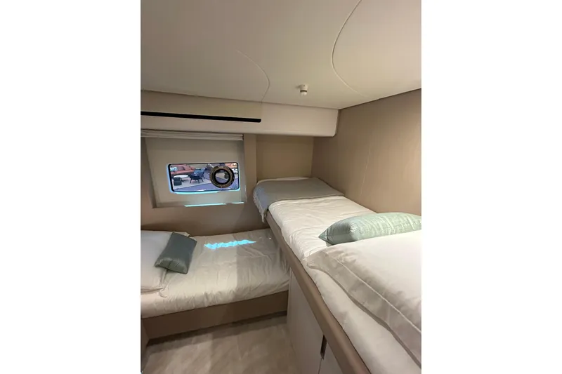 Yacht Photos Pics 2024 Azimut Fly 68 yacht cabin with twin beds and modern interior design.
