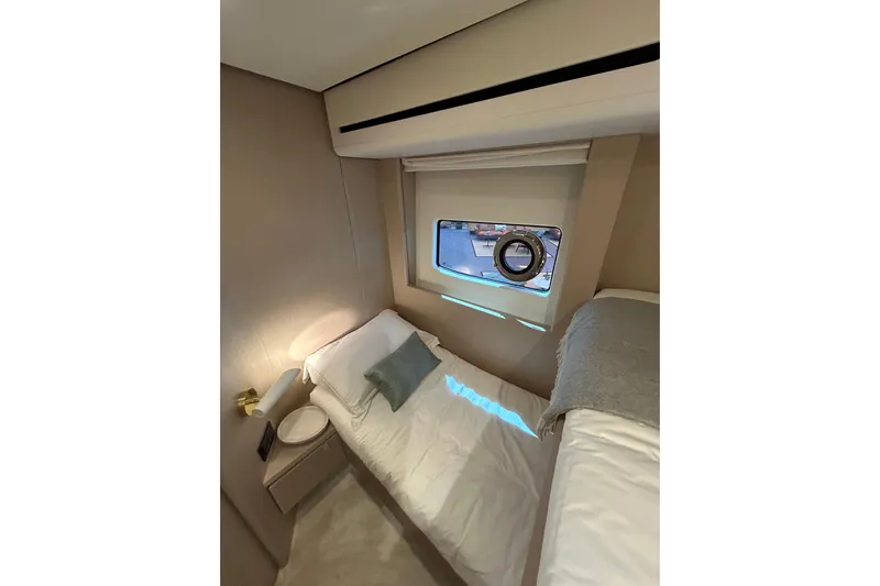  Yacht Photos Pics Luxurious cabin interior of 2024 Azimut Fly 68 yacht with cozy bed and window view.