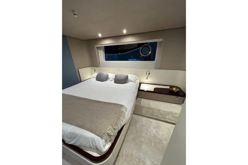  Yacht Photos Pics Luxurious bedroom interior of 2024 Azimut Fly 68 yacht with modern design and cozy bedding.