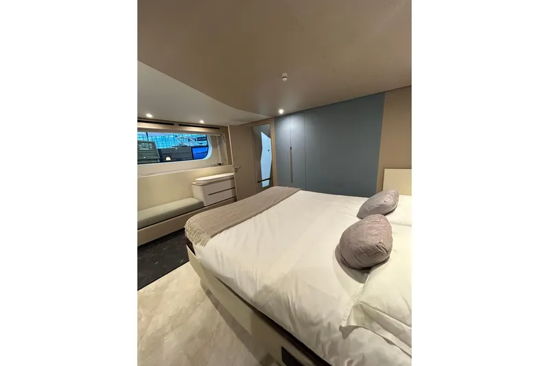  Yacht Photos Pics Luxurious bedroom interior of 2024 Azimut Fly 68 yacht with modern design and cozy ambiance.