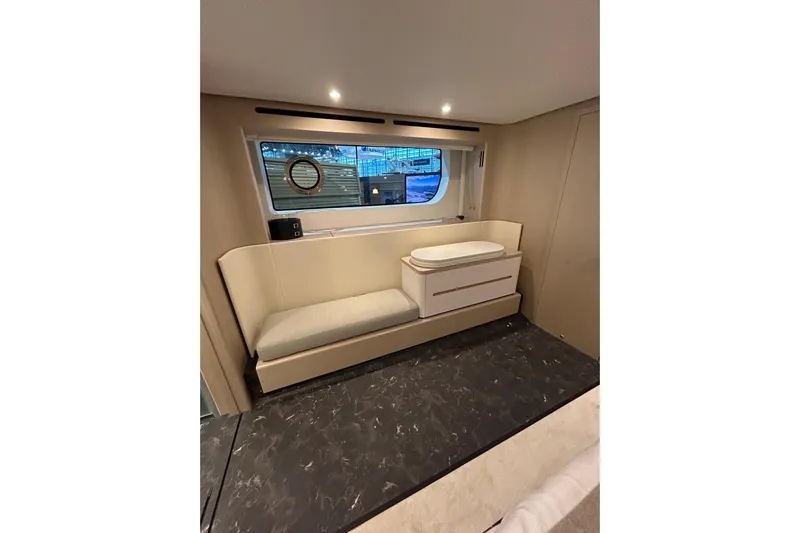  Yacht Photos Pics Luxurious interior of 2024 Azimut Fly 68 yacht with elegant seating and window view.