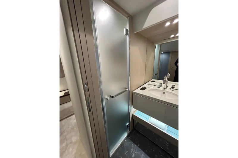  Yacht Photos Pics Luxurious bathroom in 2024 Azimut Fly 68 yacht with modern fixtures and frosted glass shower.