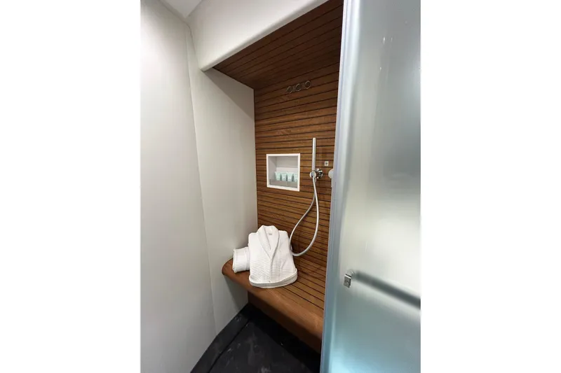  Yacht Photos Pics Luxurious shower area in 2024 Azimut Fly 68 yacht with wooden accents and modern fixtures.