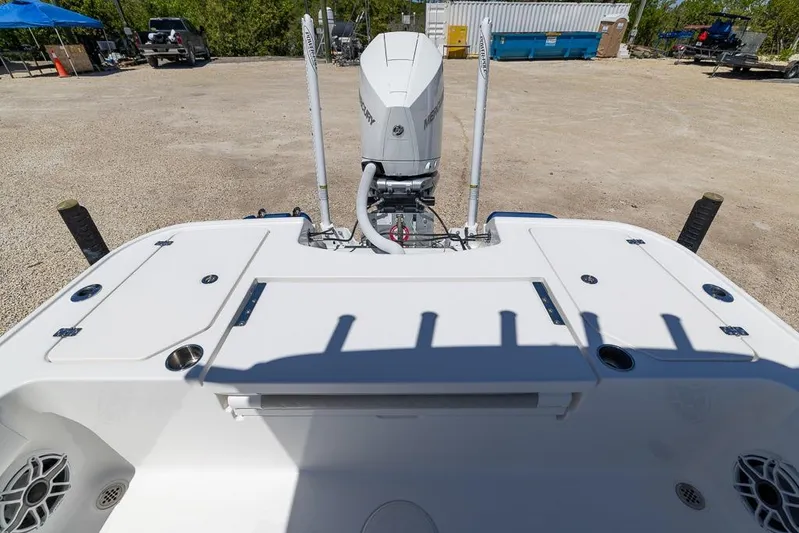  Yacht Photos Pics 2022 Caymas 26 HB boat with Mercury engine, parked on gravel lot.