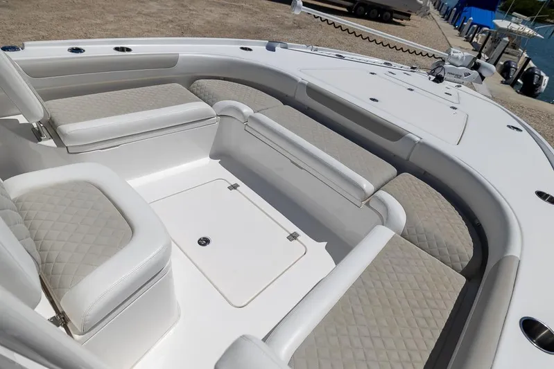  Yacht Photos Pics 2022 Caymas 26 HB boat interior with cushioned seating and storage compartments.