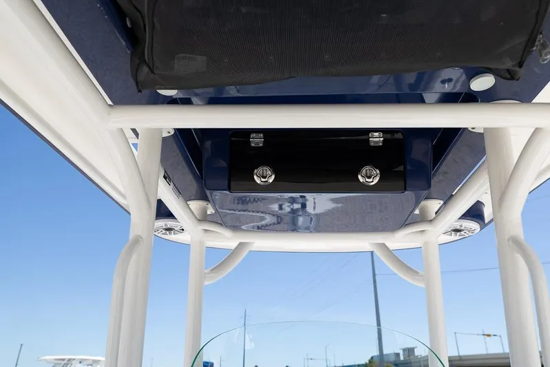  Yacht Photos Pics 2022 Caymas 26 HB boat T-top structure with speakers and storage compartment.