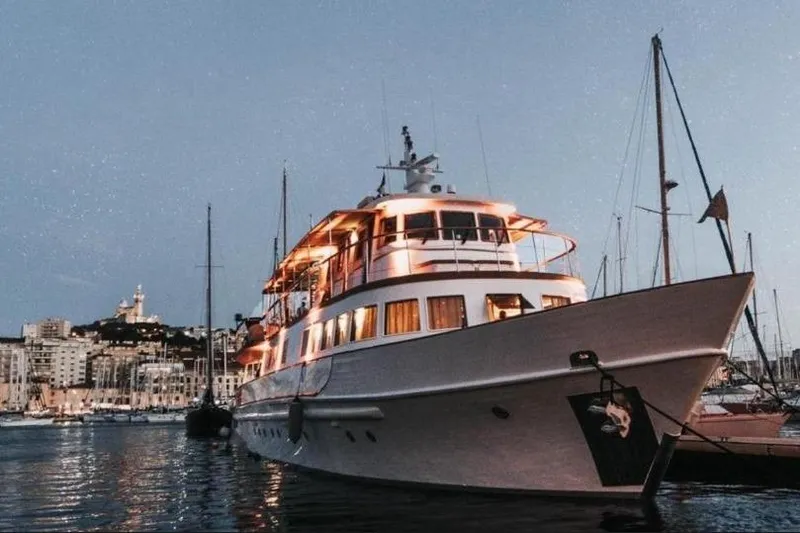 Clara One Yacht Photos Pics Custom 1961 yacht model 90 docked at a marina during twilight.