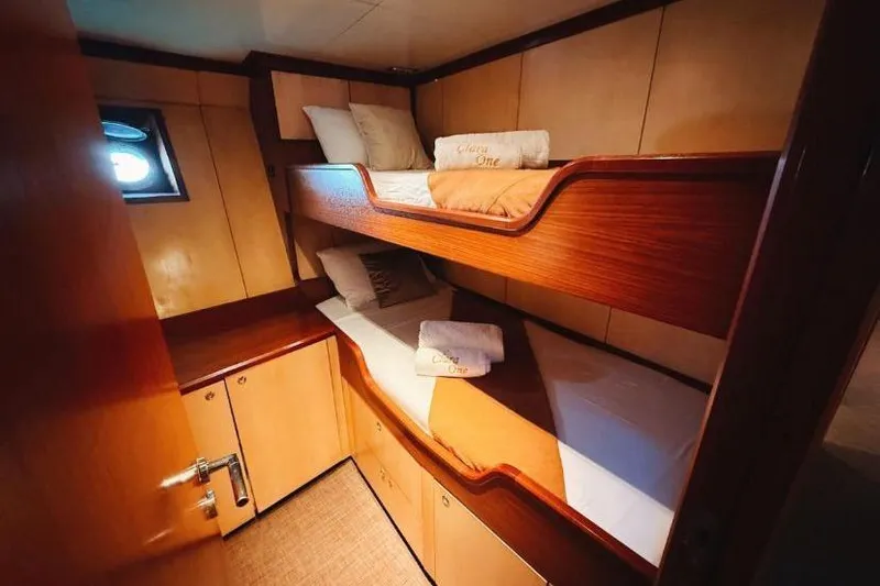 Clara One Yacht Photos Pics Cozy 1961 Custom 90 yacht cabin with wooden bunk beds and soft lighting.
