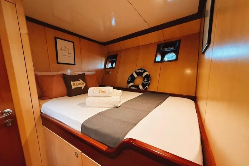 Clara One Yacht Photos Pics Cozy cabin interior on a 1961 Custom 90 yacht with nautical decor.