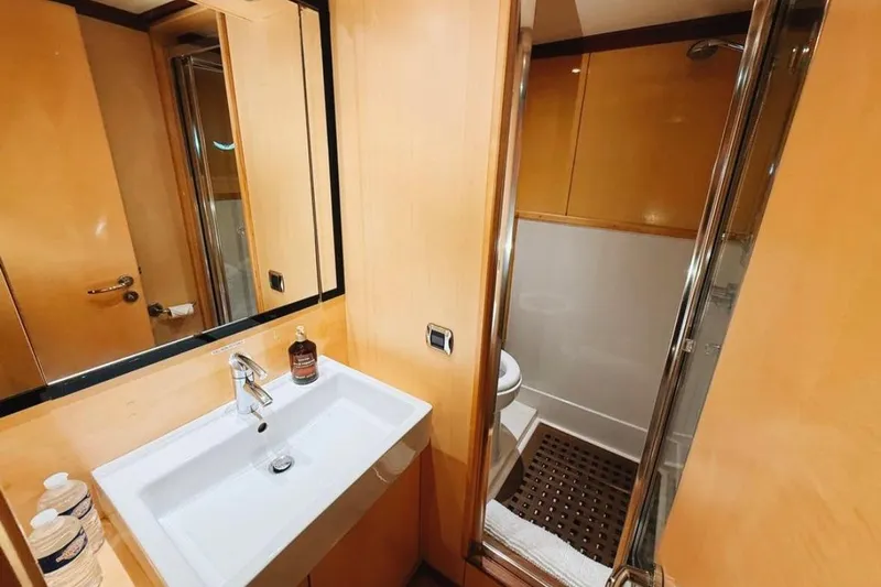 Clara One Yacht Photos Pics Compact bathroom with modern sink, mirror, and shower in a 1961 Custom model 90.