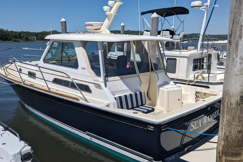  Yacht Photos Pics 2008 Sabre 34 Express boat docked at marina, featuring sleek design and comfortable seating.