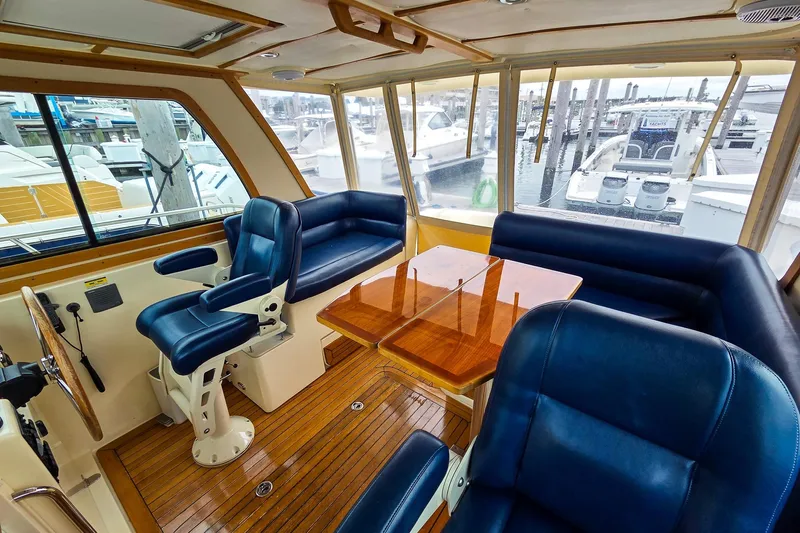  Yacht Photos Pics Interior of 2008 Sabre 34 Express yacht with blue seating and wooden table.