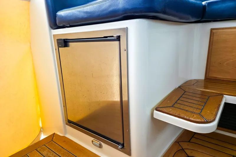  Yacht Photos Pics 2008 Sabre 34 Express interior with built-in fridge and wooden steps.