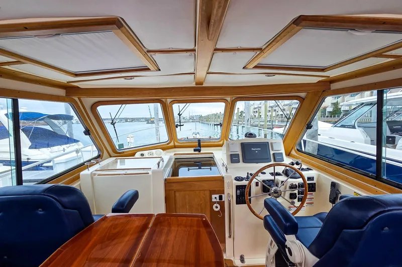  Yacht Photos Pics Interior view of 2008 Sabre 34 Express yacht helm with wooden accents and navigation equipment.