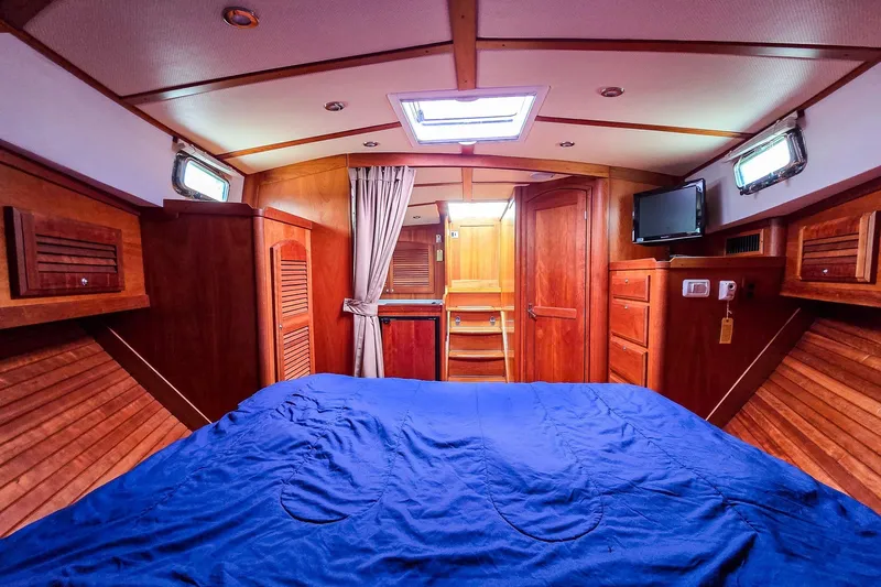  Yacht Photos Pics Luxurious cabin interior of 2008 Sabre 34 Express yacht with wood finish and blue bedding.