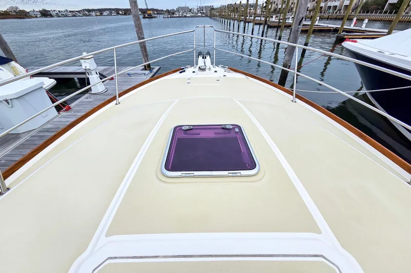  Yacht Photos Pics 2008 Sabre 34 Express yacht deck with hatch, docked by the water.