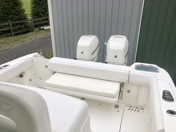  Yacht Photos Pics 2016 Boston Whaler OUTRAGE boat with dual outboard motors and white seating.