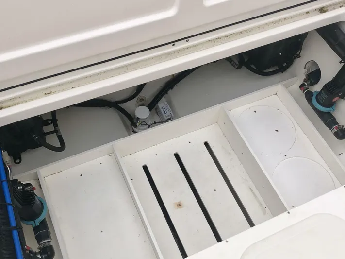  Yacht Photos Pics 2016 Boston Whaler OUTRAGE boat interior, showcasing storage compartments and equipment.