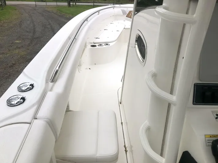  Yacht Photos Pics 2016 Boston Whaler OUTRAGE boat interior with white seating and sleek design.