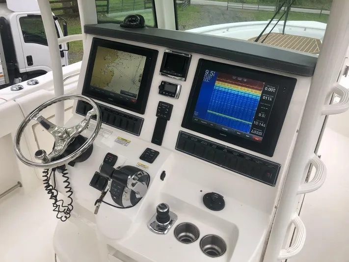  Yacht Photos Pics 2016 Boston Whaler OUTRAGE boat dashboard with navigation and control systems.