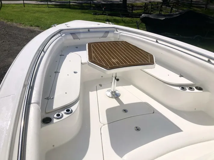  Yacht Photos Pics 2016 Boston Whaler OUTRAGE boat interior with seating and wooden table.