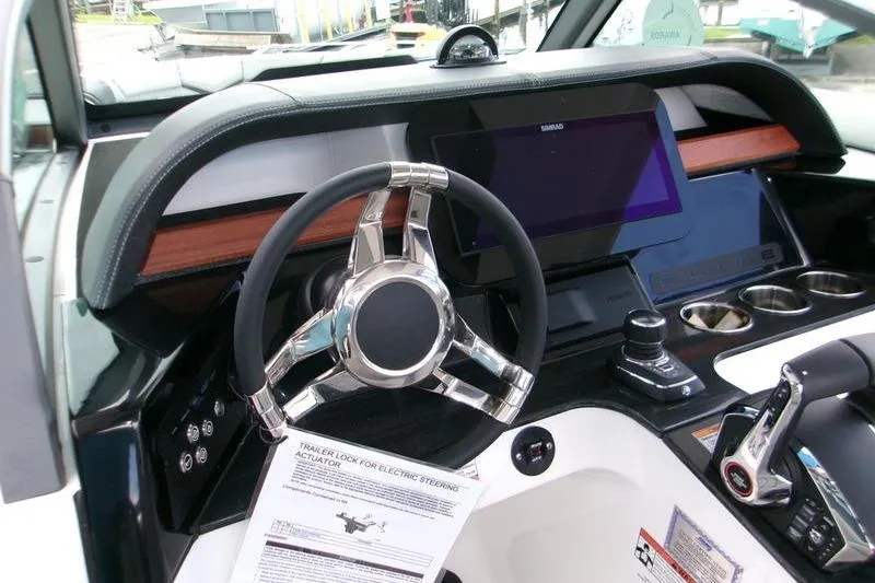  Yacht Photos Pics 2026 Monterey Elite 30 OB boat dashboard with modern steering wheel and digital display.