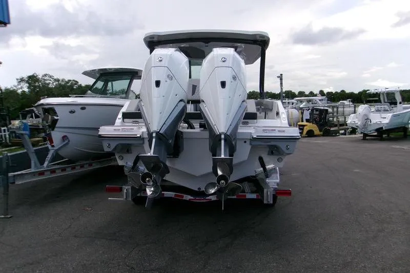  Yacht Photos Pics 2026 Monterey Elite 30 OB boat with dual outboard engines, parked on a trailer.