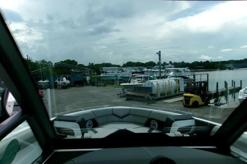 Yacht Photos Pics View from 2026 Monterey Elite 30 OB boat, overlooking marina with docked boats and forklift.