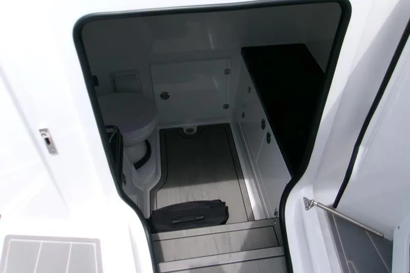  Yacht Photos Pics Interior view of 2026 Monterey Elite 30 OB boat bathroom with toilet and storage.