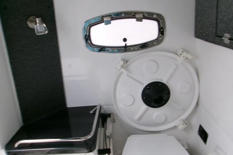  Yacht Photos Pics Interior of 2026 Monterey Elite 30 OB boat, featuring a compact bathroom with a porthole.