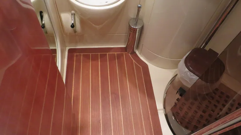 1299 Yacht Photos Pics Bathroom interior of 1996 Sunseeker Predator 63 yacht with wood flooring and modern fixtures.