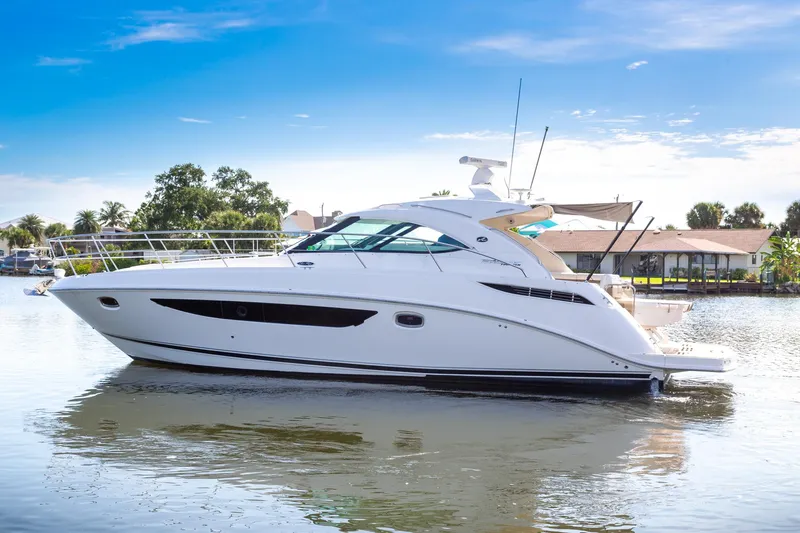 Yacht Photos Pics 2013 Sea Ray 410 Sundancer yacht on calm water under clear blue sky.