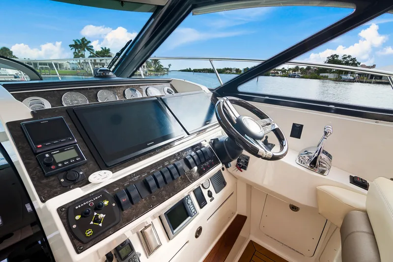  Yacht Photos Pics Helm of 2013 Sea Ray 410 Sundancer yacht with modern controls and scenic water view.