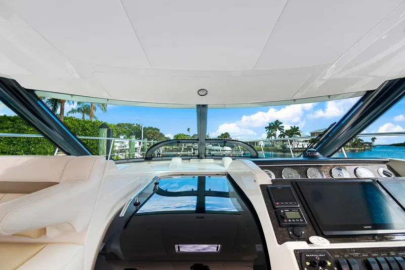  Yacht Photos Pics Interior view of 2013 Sea Ray 410 Sundancer yacht cockpit with modern controls and scenic waterway.