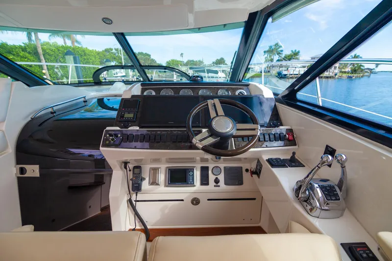  Yacht Photos Pics 2013 Sea Ray 410 Sundancer helm with steering wheel, controls, and navigation instruments.