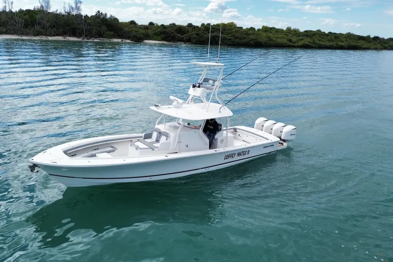  Yacht Photos Pics 2018 Regulator 41 boat on calm water, featuring triple outboard engines.