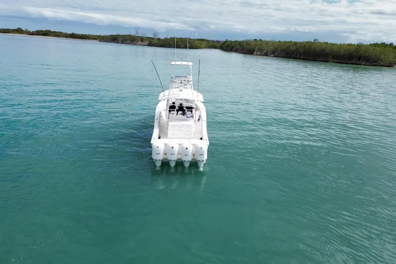  Yacht Photos Pics 2018 Regulator 41 boat on calm turquoise water, surrounded by lush greenery.