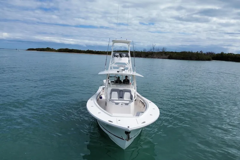  Yacht Photos Pics 2018 Regulator 41 boat on calm water with distant shoreline and cloudy sky.