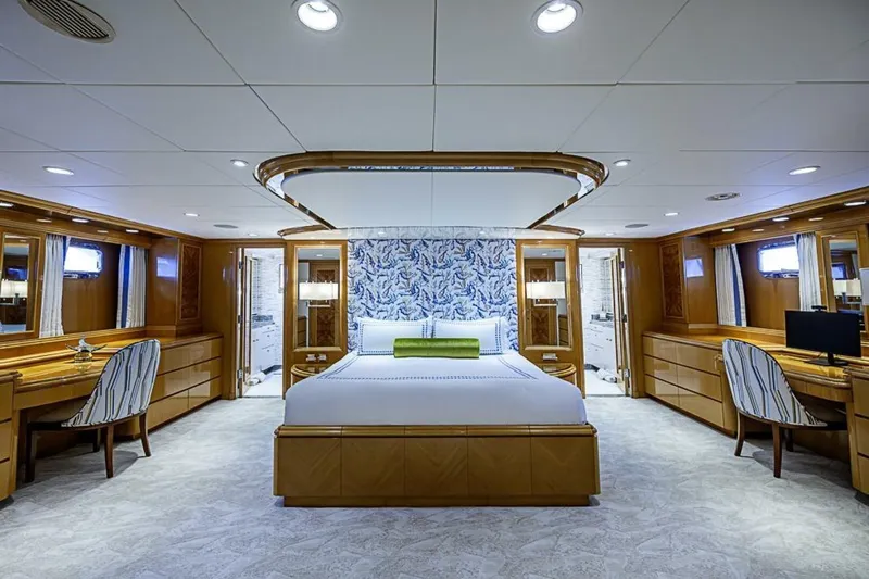 Probability Yacht Photos Pics Luxurious bedroom interior of 1997 Delta 122 Tri-Deck Motor Yacht with elegant wood furnishings.
