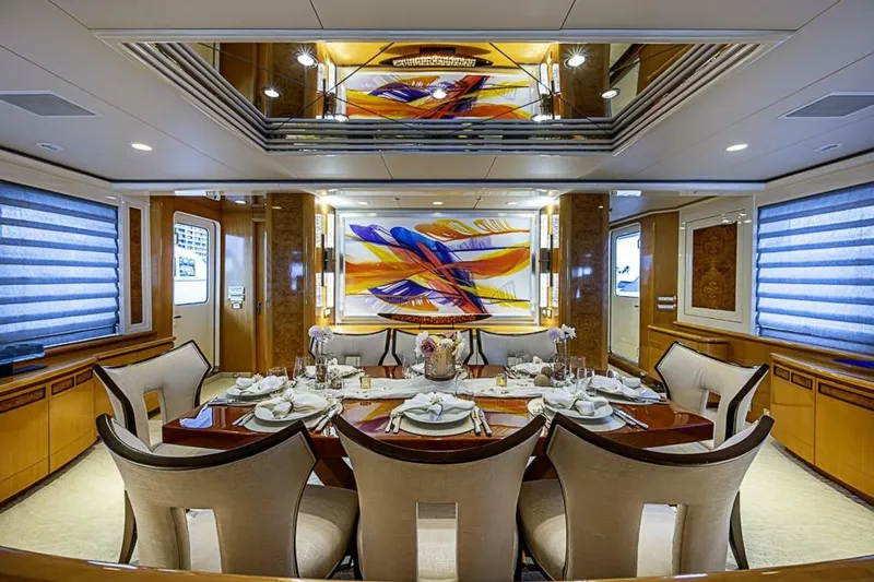 Probability Yacht Photos Pics Luxurious dining area on 1997 Delta 122 Tri-Deck Motor Yacht with elegant decor and modern art.