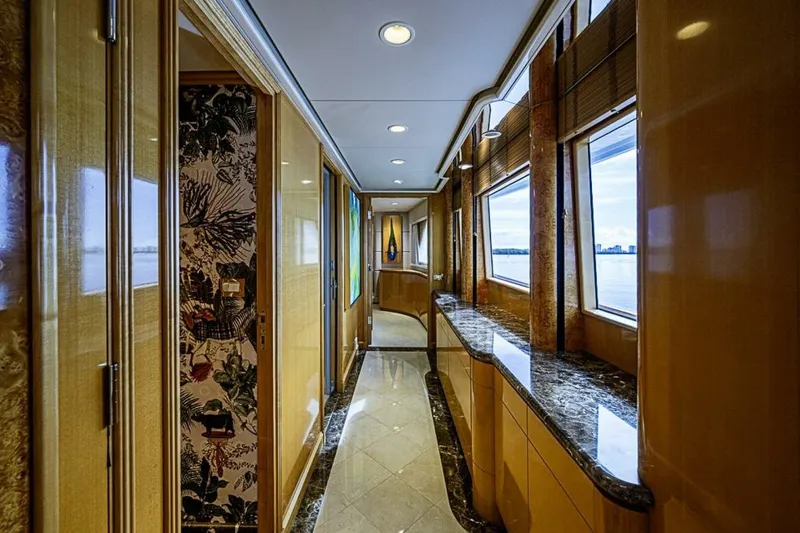 Probability Yacht Photos Pics Luxurious interior hallway of 1997 Delta 122 Tri-Deck Motor Yacht with elegant wood and marble finishes.