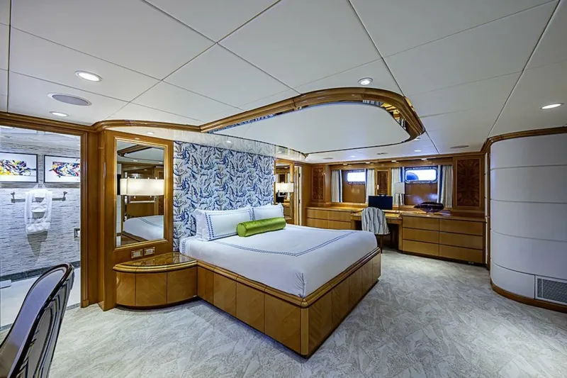 Probability Yacht Photos Pics Luxurious bedroom interior of 1997 Delta 122 Tri-Deck Motor Yacht with elegant wood finishes.