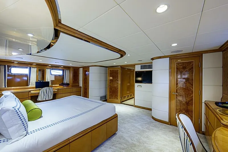 Probability Yacht Photos Pics Luxurious bedroom interior of 1997 Delta 122 Tri-Deck Motor Yacht with elegant wood finishes.