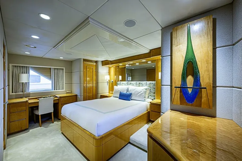 Probability Yacht Photos Pics Luxurious bedroom interior on 1997 Delta 122 Tri-Deck Motor Yacht, featuring elegant wood furnishings.
