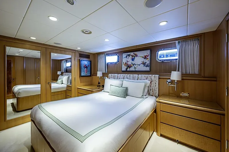 Probability Yacht Photos Pics Luxurious bedroom on 1997 Delta 122 Tri-Deck Motor Yacht with elegant wood paneling.