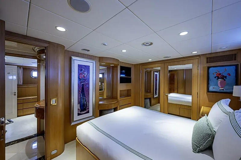 Probability Yacht Photos Pics Luxurious bedroom interior of 1997 Delta 122 Tri-Deck Motor Yacht with elegant wood paneling.